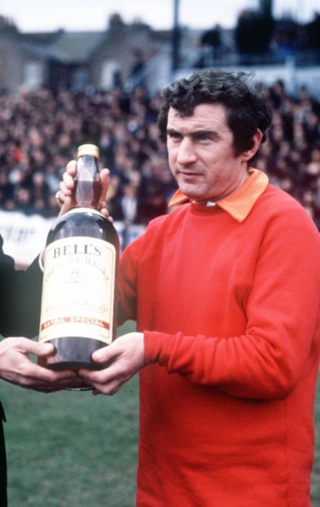 David Pleat is presented with a bottle of whisky after winning the manager of the month award during his time at Luton