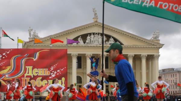 FILE - Protesters with old Belarusian national flags march at an opposition rally in Minsk, Belarus, on Sept. 6, 2020.