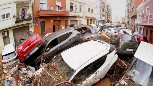 Cars are photographed piled up after being swept away by floods in Valencia, Spain.
Pic: AP
