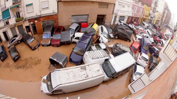 Cars are photographed piled up after being swept away by floods in Valencia.
Pic: AP